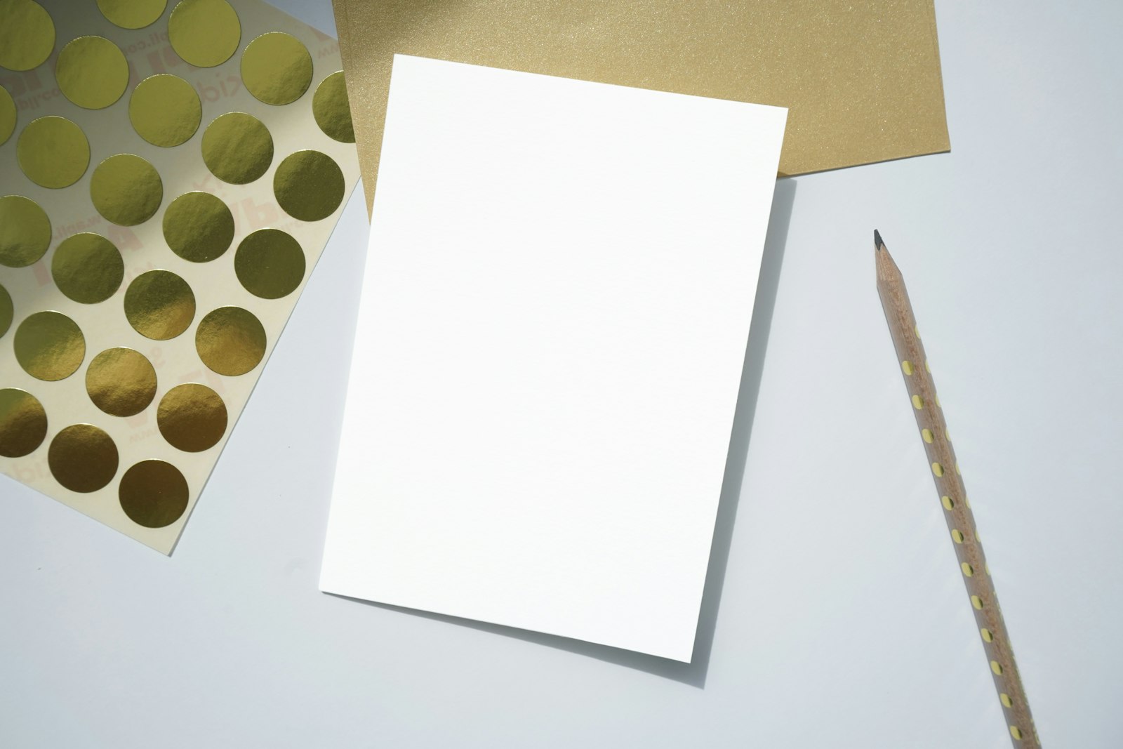 A blank sheet and a pencil on a light table, no people